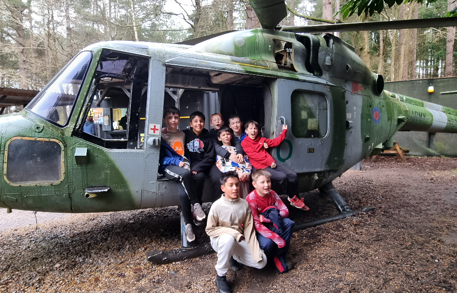 Kids birthday paintball group sitting in a helicopter
