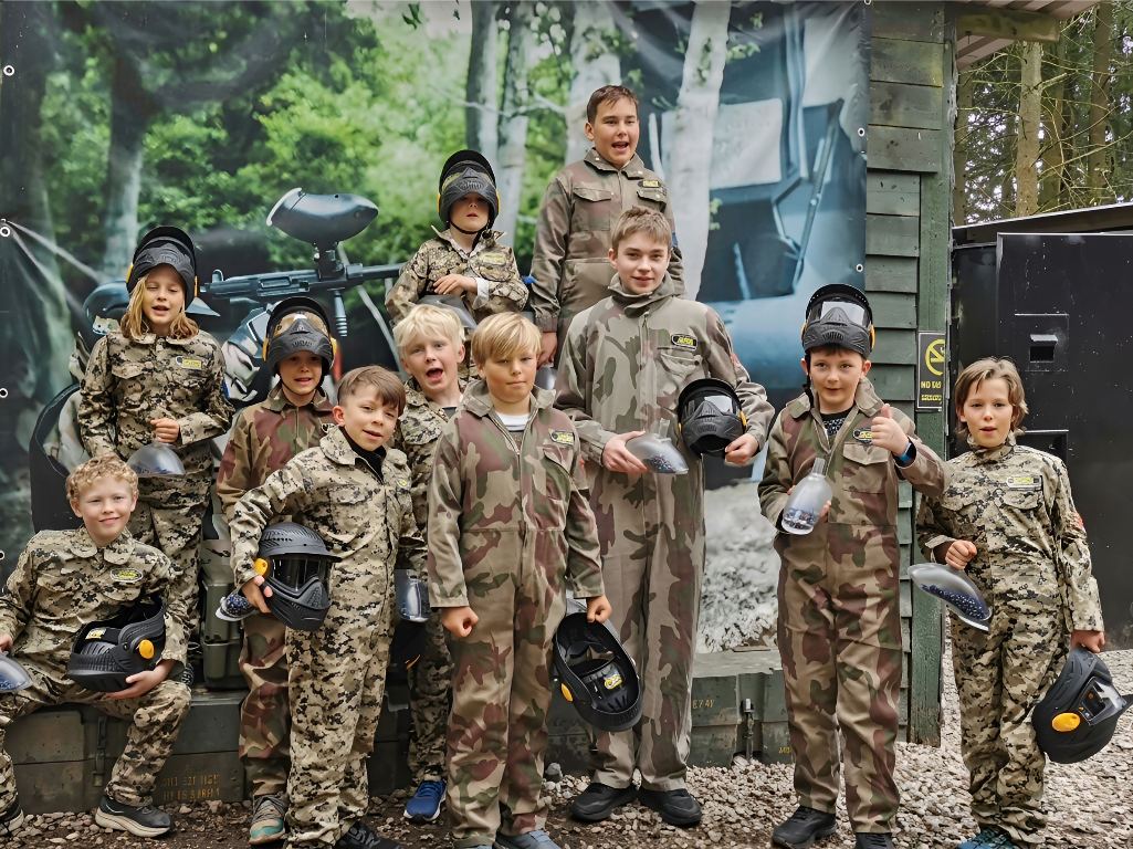 Kids paintball group in camouflage kit