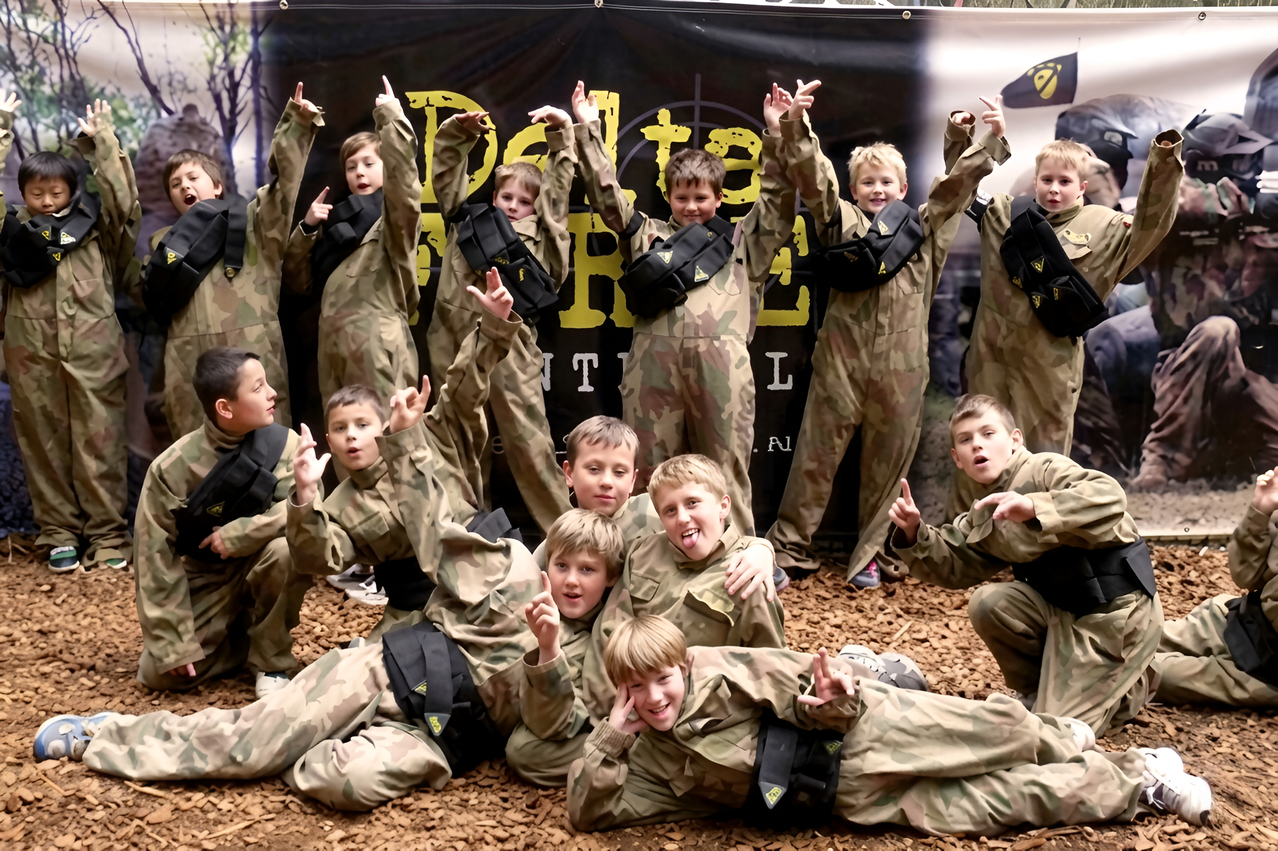 Scouts celebrating in paintball kit at Delta Force Paintball
