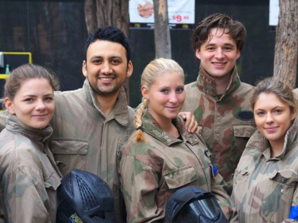 Youth group paintball players in game kit