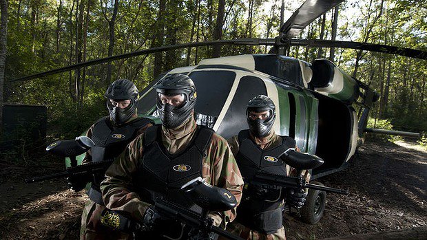 Three players pose in front of Black Hawk