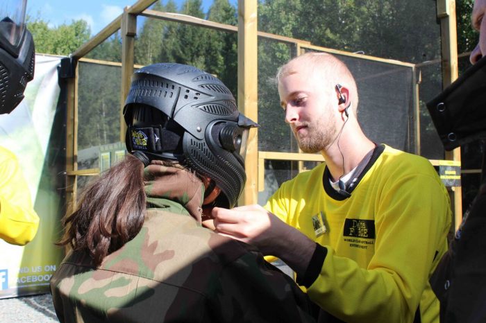 Marshal adjusts player's helmet