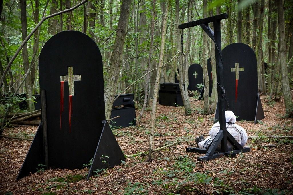 Zombie Crypt gravestones and abandoned corpse under hanging noose