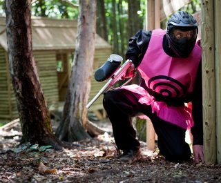 Paintball Player Dressed In Pink Target On Game Zone