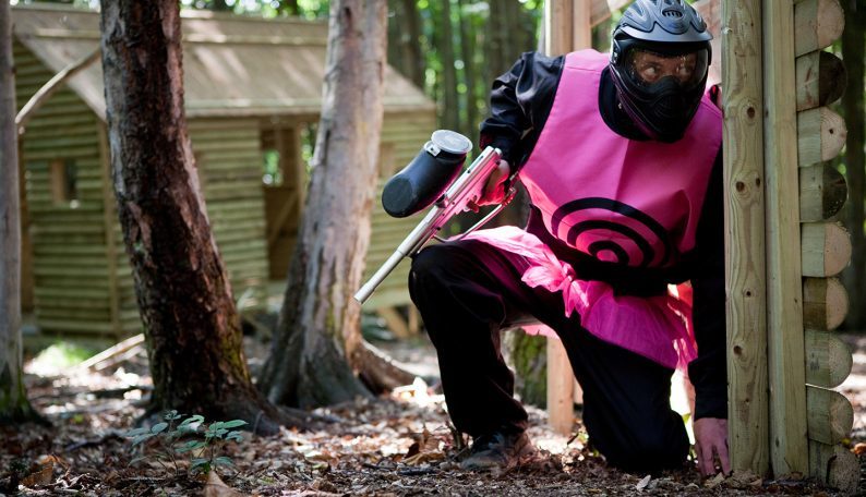 Crouched Delta Force Paintball Player In Pink