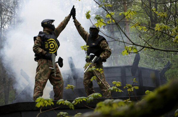 Two players wearing target vests high five