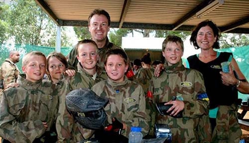 Family smiling at Delta Force base camp