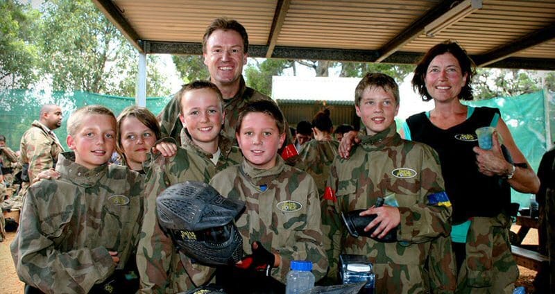 Family smiling at Delta Force Paintball base camp