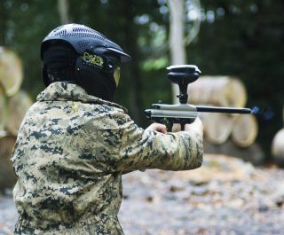 Kid Holding Mini Paintball Gun Wearing Kit