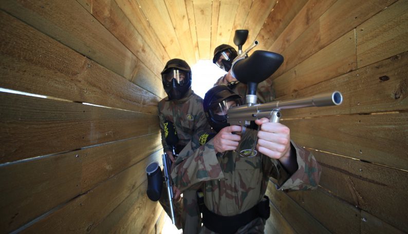 Delta Force Paintball Players Pose In Narrow Walkway