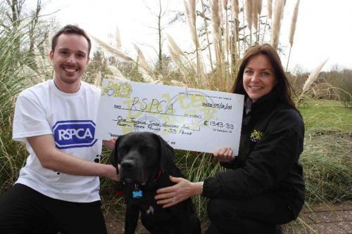 Delta Force Staff Holding Cheque With RSPCA