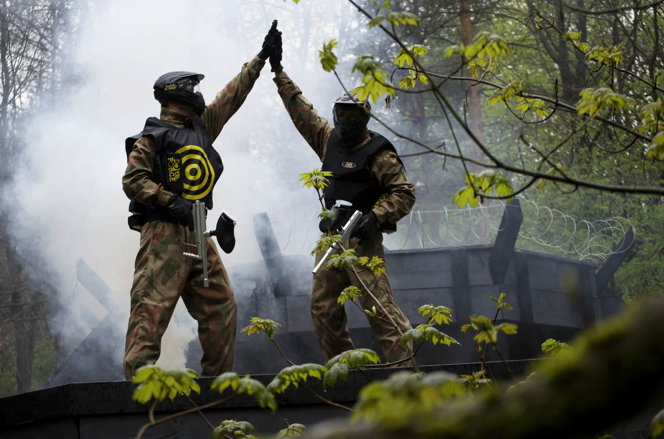 Two Paintball Players High Five