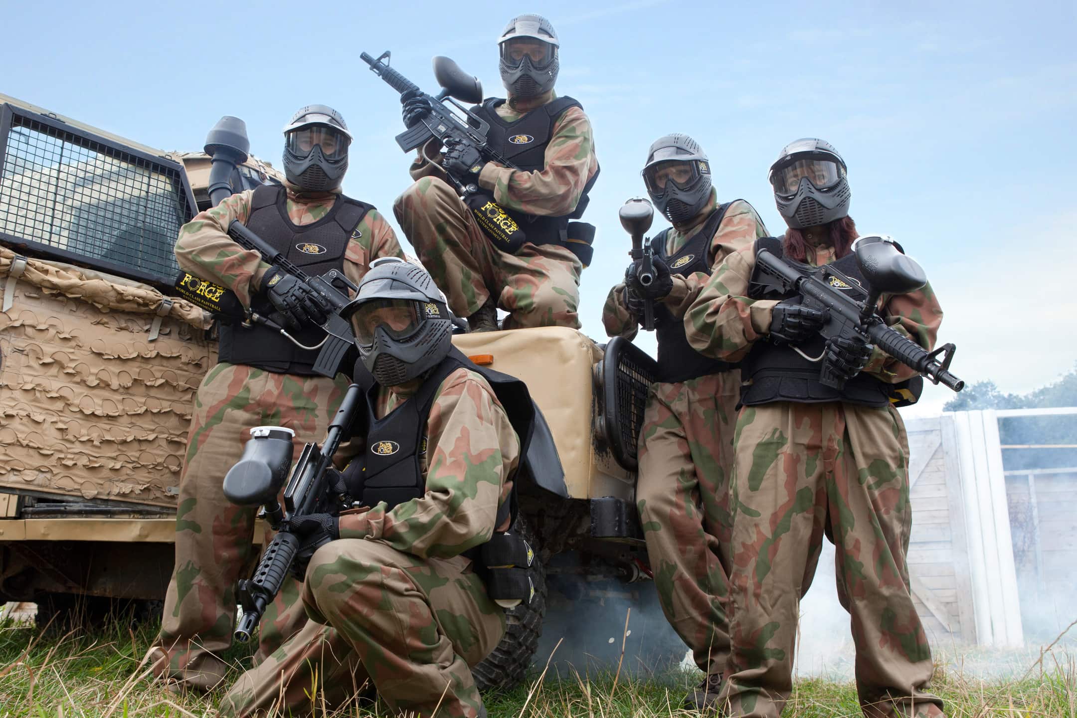 Paintball Players Pose Against Armoured Truck