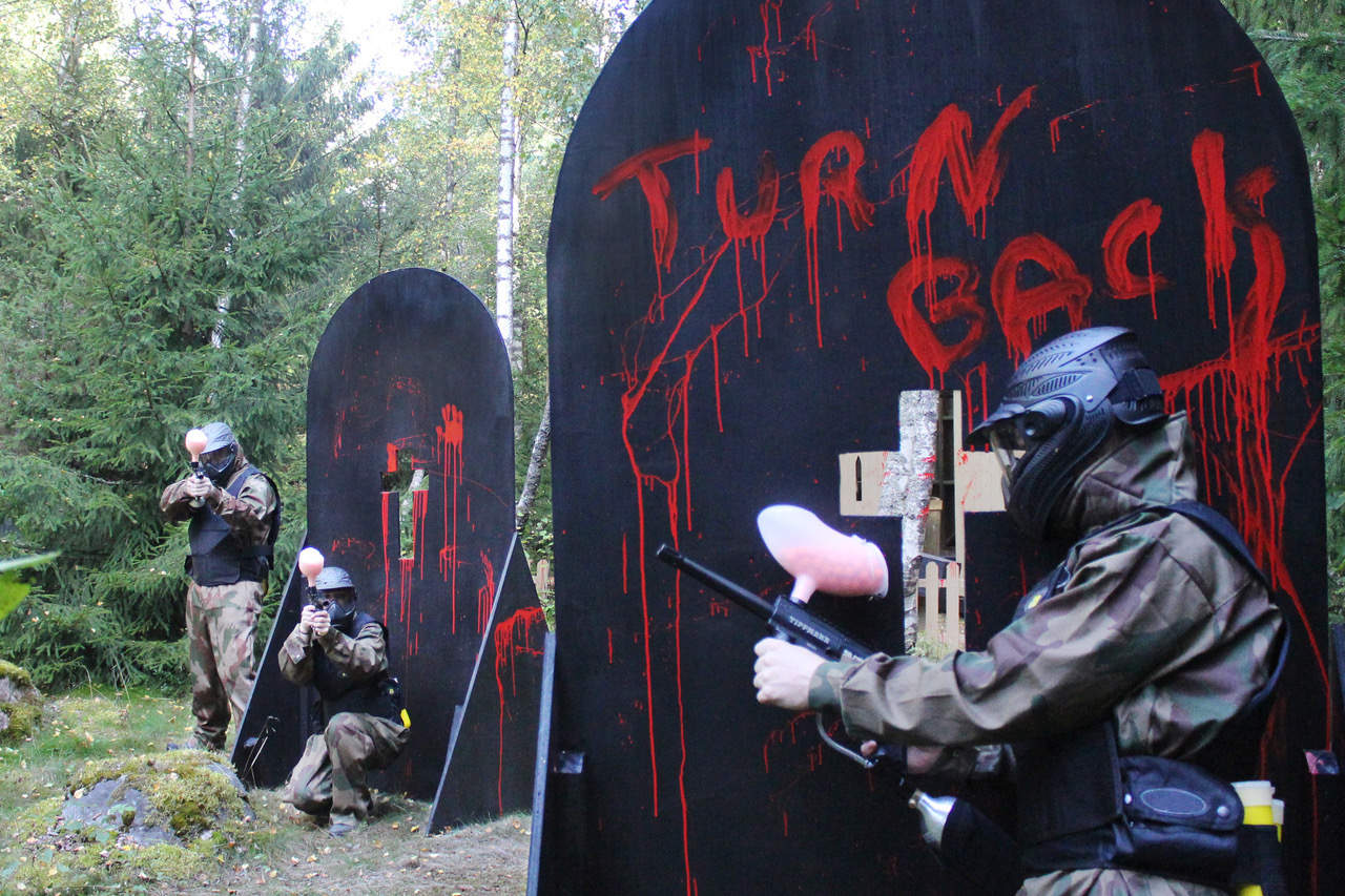 Paintball Players Exchange Fire Behind Bloody Gravestones