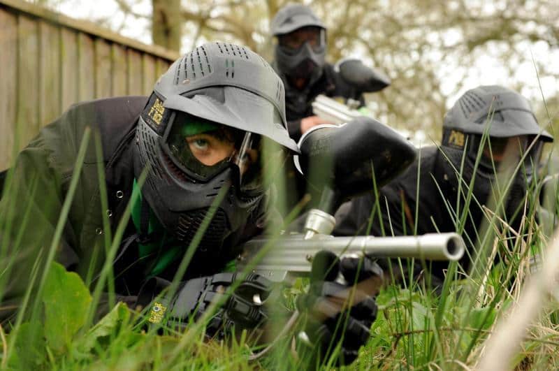 Players lie waiting in grass