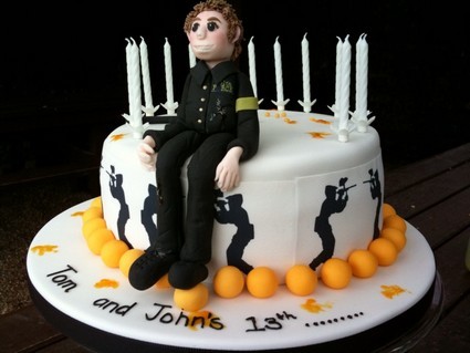 Edible paintball player sits on paintballing birthday cake