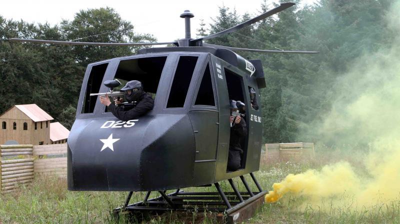 Player shoots out of chopper window against smoke background