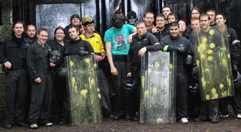 Players pose with paintball shields