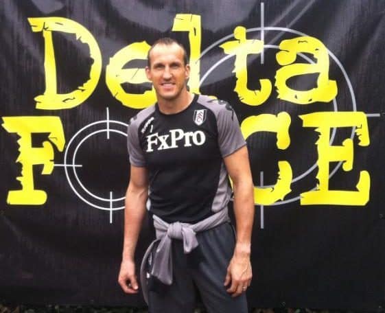 Fulham player poses before Delta Force logo