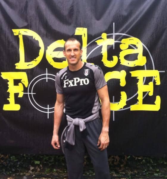 Fulham player poses before Delta Force logo