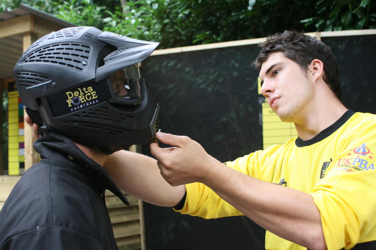Marshal assisting player wearing helmet