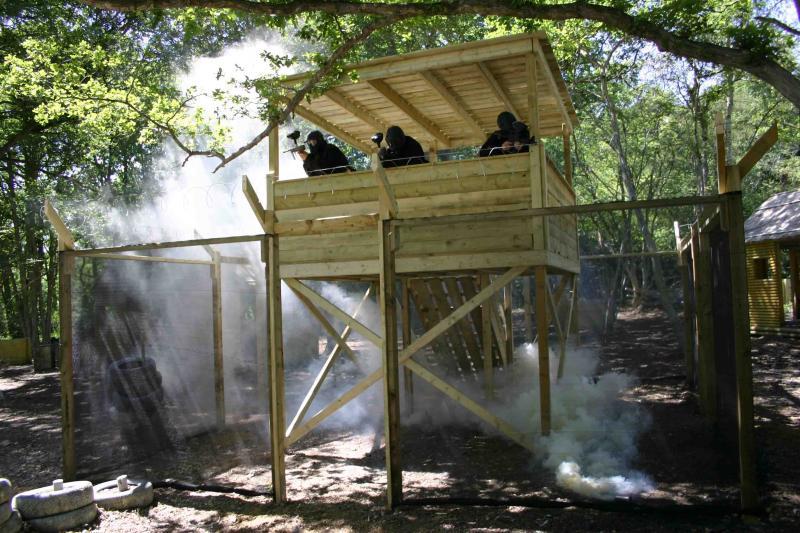 Three players guard tower surrounded by fencing