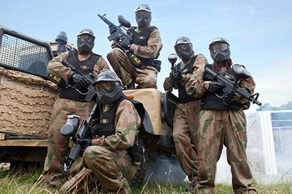 Players pose with M16s and camouflaged truck