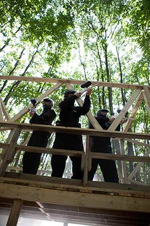 Three players guard wooden outpost