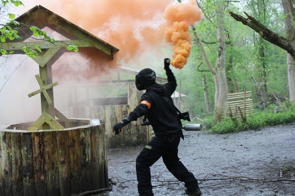 Player prepares to throw smoking grenade