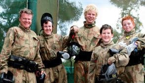 Boys smiling in Delta Force paintball gear