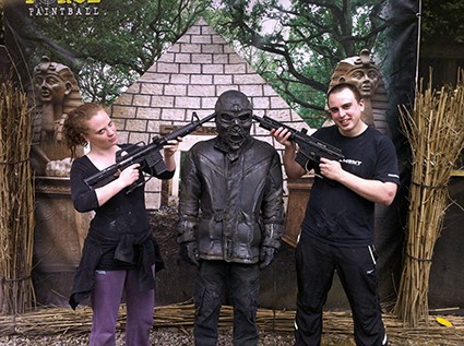 Two players hold paintball guns to Terminator's head