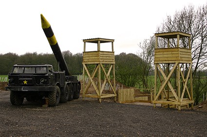 Rocket-mounted truck next to two tower outposts