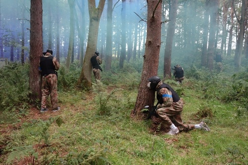 Newcastle players taking cover behind trees