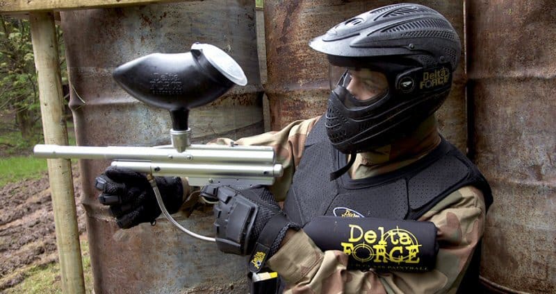 Paintball Player Hiding and Holding Paintball Gun