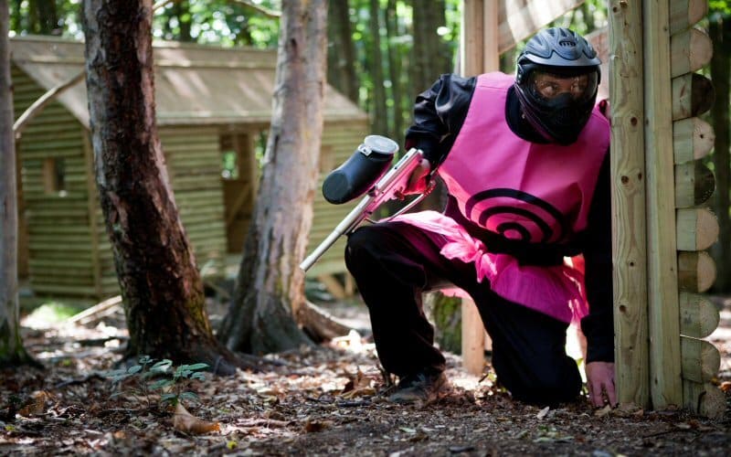 Crouching player in pink target vest