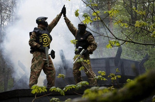 Two Paintball Players High Five Each Other