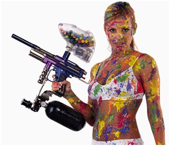 Woman in underwear covered in paint holding paintball gun