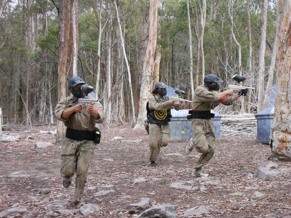 Three players run while shooting sideways