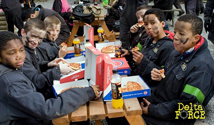 Kids eat pizza at base camp