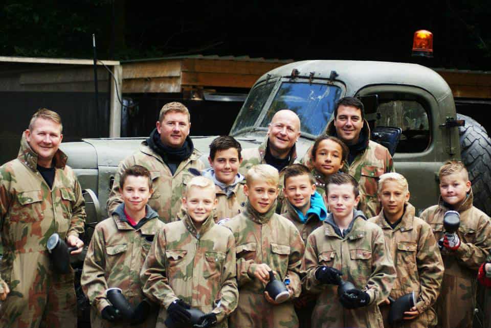 School group smiling at Delta Force Paintball base camp