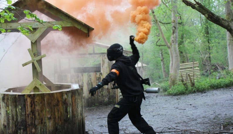 Paintball Player Throwing Smoke Grenade