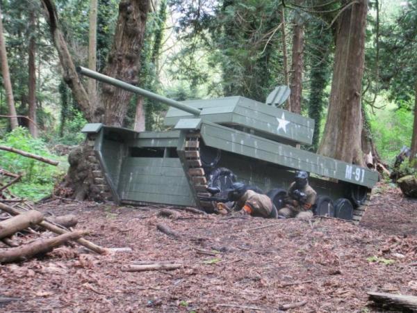 Players take cover on side of tank