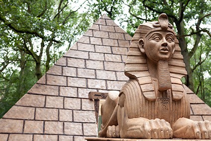 Sphinx statue in front of pyramid