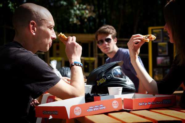 Man watches couple eat pizza