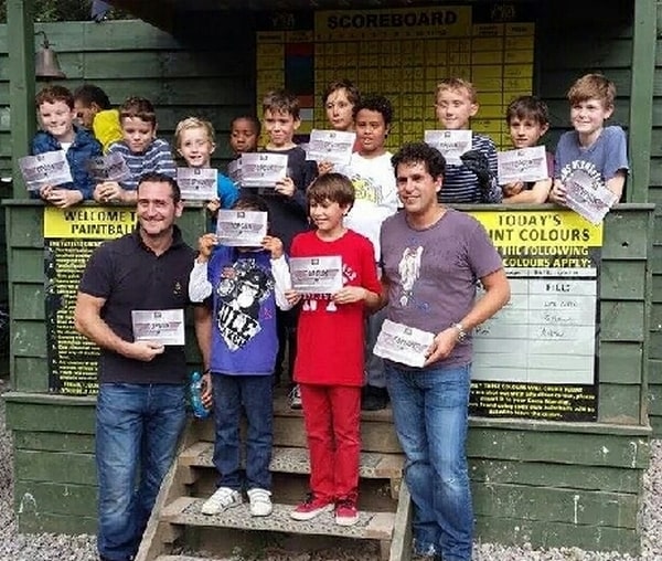 Will Mellor, son, and team pose at base camp