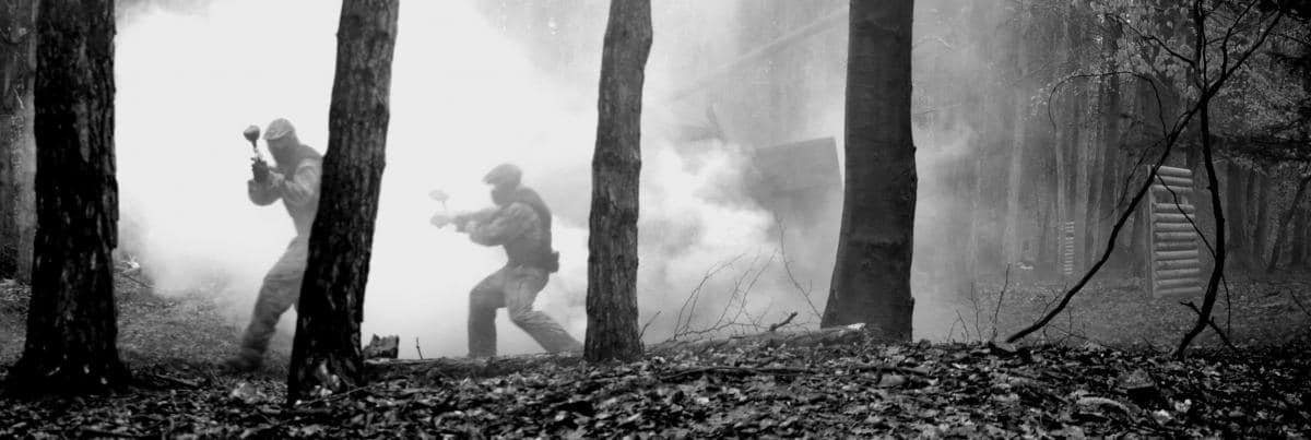 Players in smoke and trees black and white