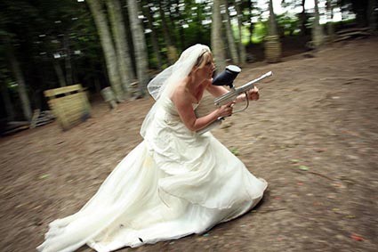 Bride crouches on the move with gun