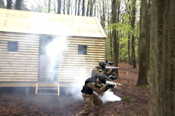 Two players advance round smoking hut